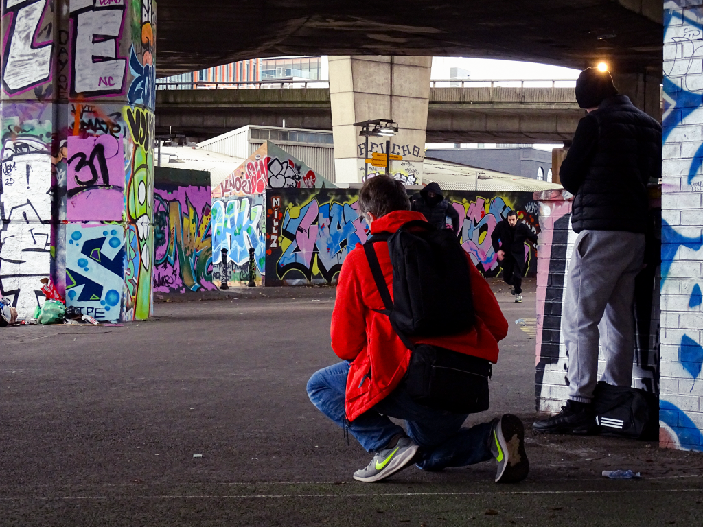 Director filming actors running.