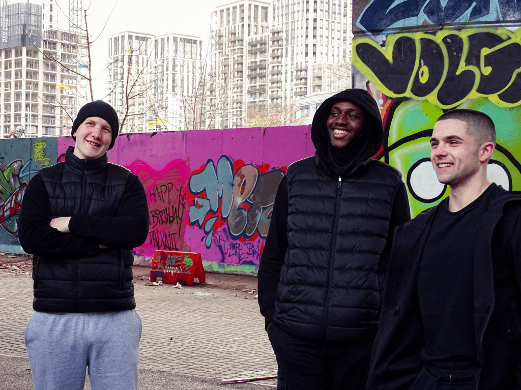 Three actors smiling.