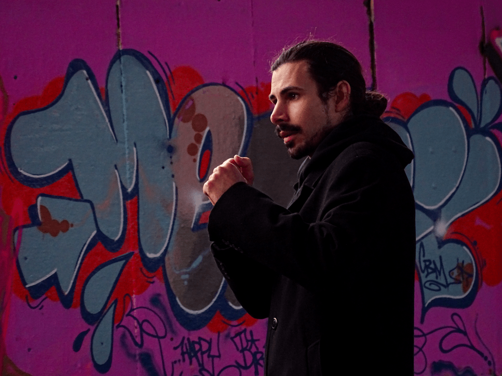 Actor filming a take with his fists raised.