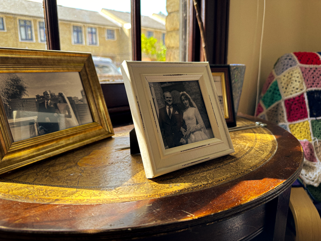 Two framed black and white photos of a young couple on their wedding day.