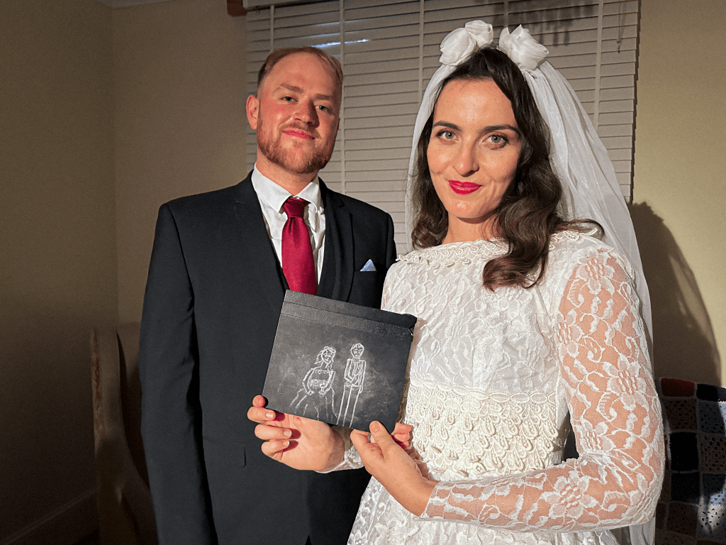 Actors posing with clapper board.